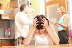 Child from EL Paso holds her head in frustration as her parents argue